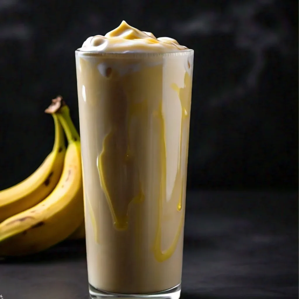 A Cook Out fresh banana shake with two bananas behind.